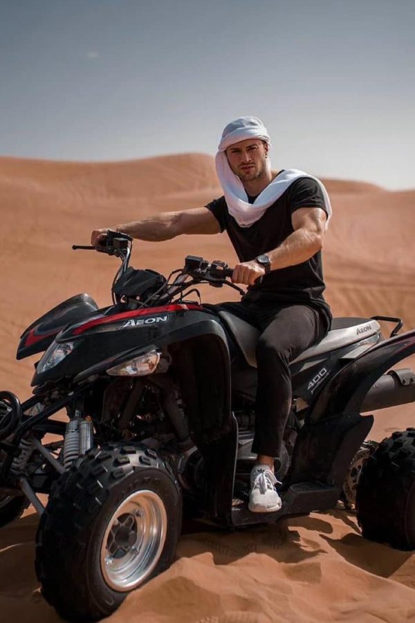 Rider with white head wrap sitting on a black 400 AEON quad during a Polaris quad tour